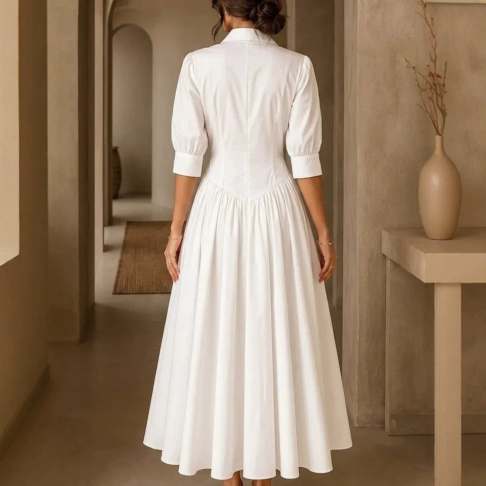 Woman wearing a white dress in a warm-toned interior setting