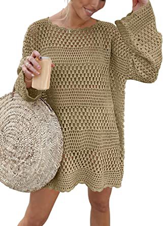 Woman wearing a beige crochet dress holding a phone and a woven bag.