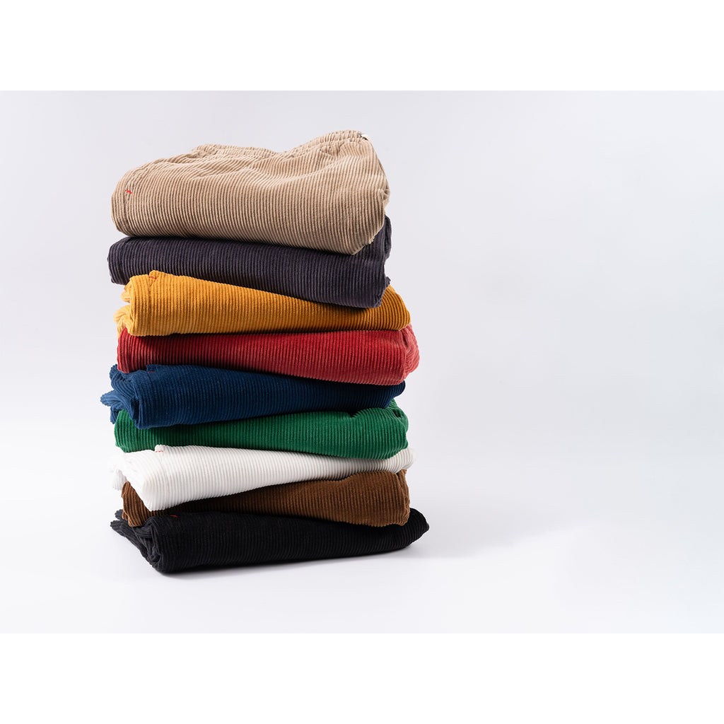 Stack of colorful sweaters on a white background