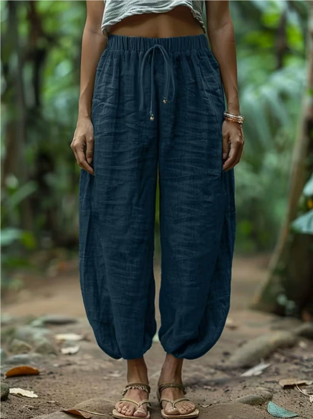 Person wearing blue pants with a blurred natural background