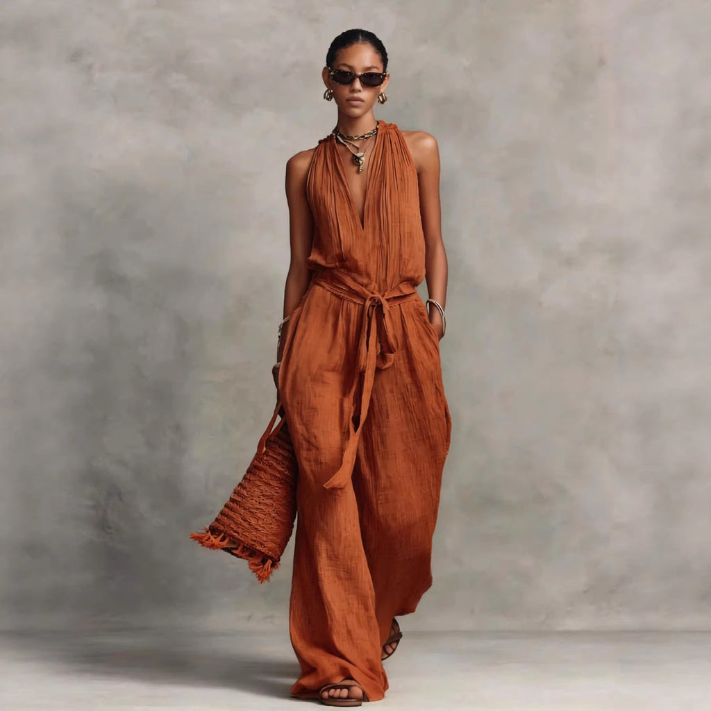 Woman wearing a rust-colored dress against a gray background