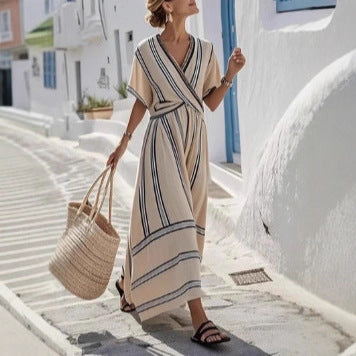 Woman in a striped dress walking on a white alleyway with blue accents