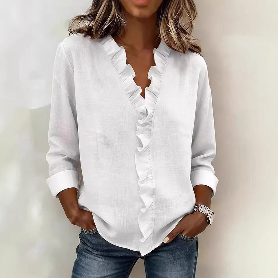 White ruffled blouse worn by a person with a neutral background