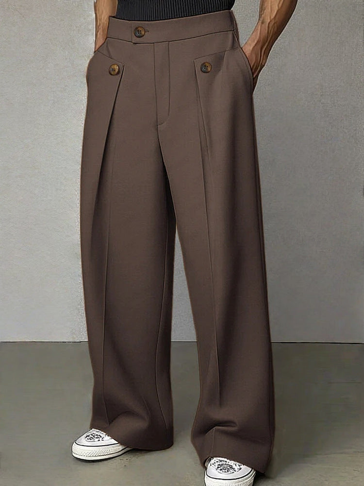 Brown wide-leg pants worn by a person on a gray background