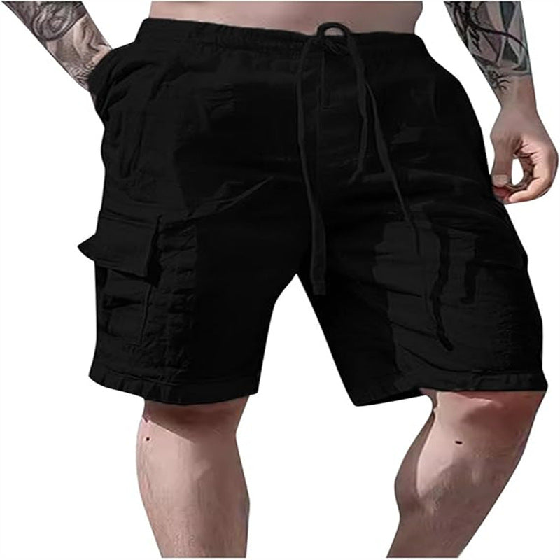 Black cargo shorts worn by a person on a white background