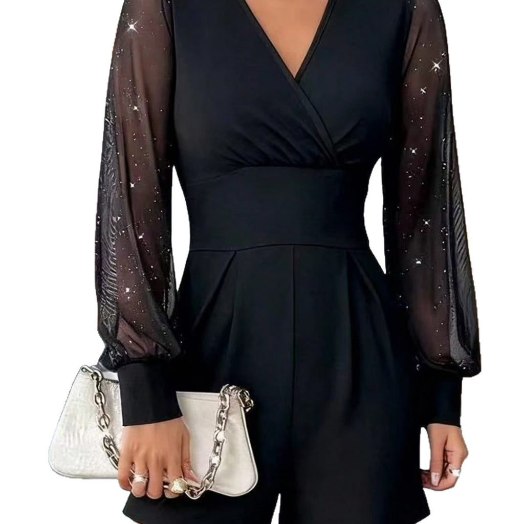 Black dress with sheer sleeves and a white handbag held by a person on a white background