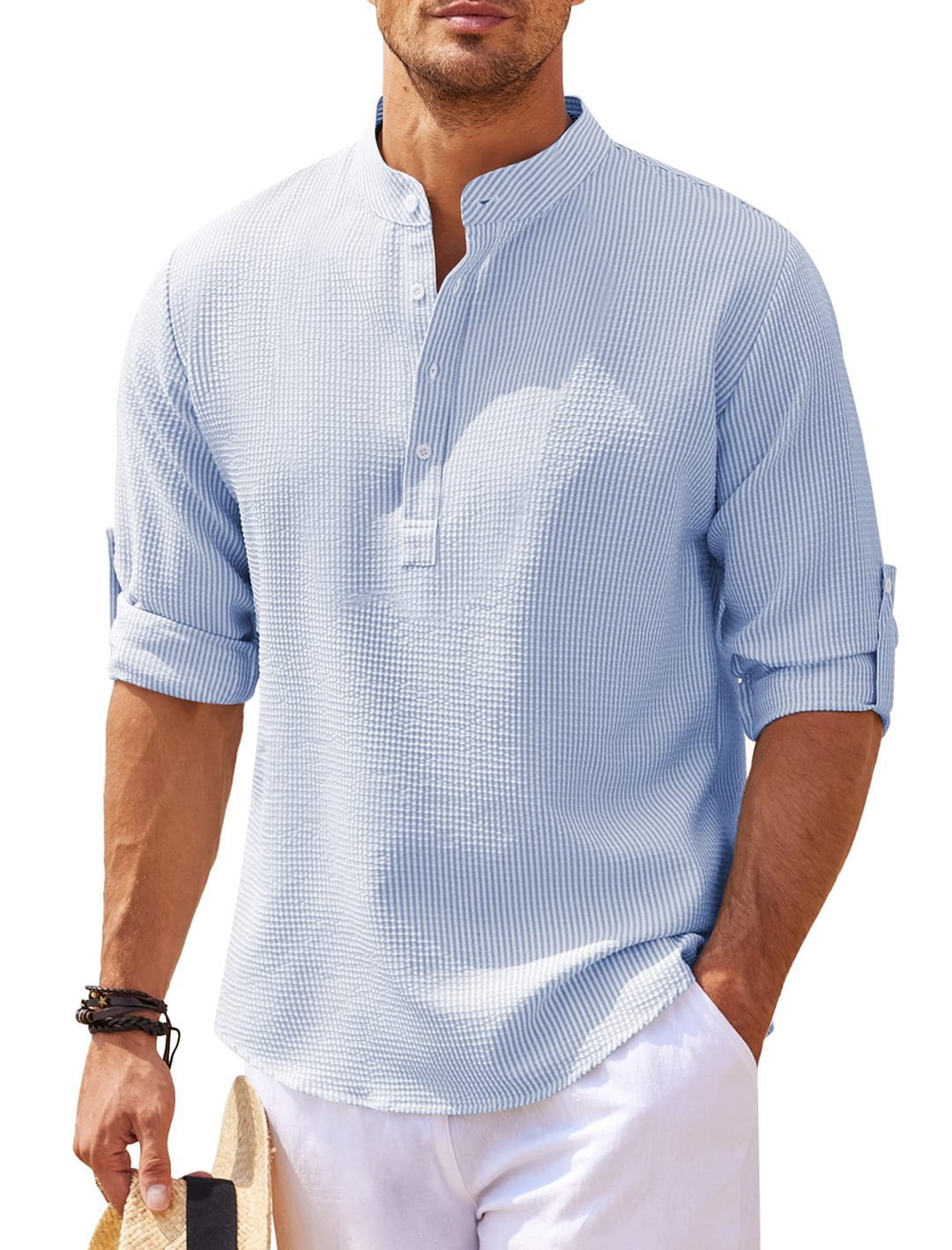 Man wearing a light blue checkered shirt with rolled-up sleeves on a white background