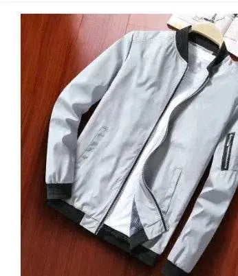 ZA-Zola loose-fit men's baseball jacket in light grey with black trim, displayed on hanger.