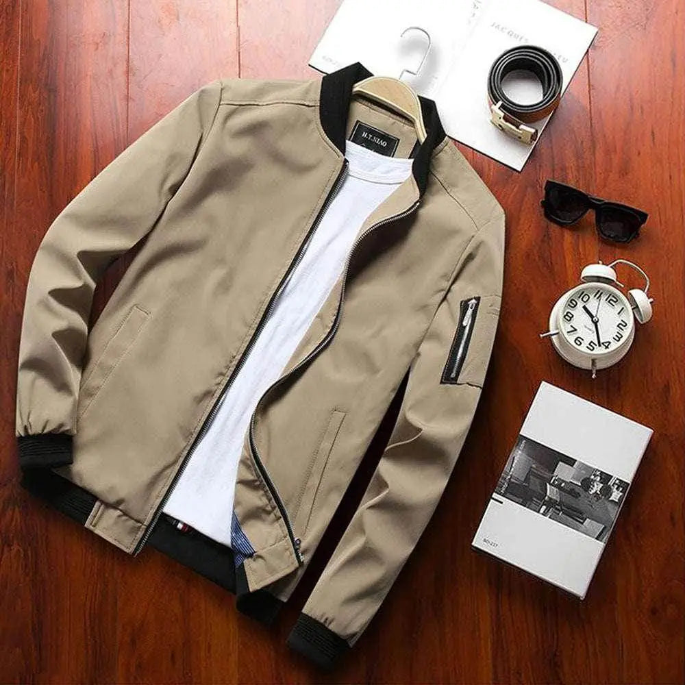 Men’s beige bomber jacket with black collar by ZA-Zola, styled on wood with accessories