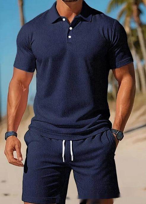 Man wearing navy mesh polo shirt and shorts set from ZA-Zola, summer beach background