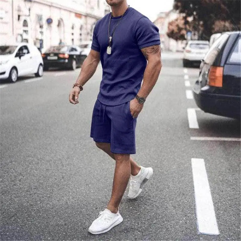 Man wearing navy blue summer sportswear set with tee and shorts from ZA-Zola on city street