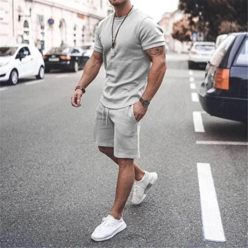 Man wearing light grey summer sportswear set with tee and shorts outdoors, ZA-Zola fashion