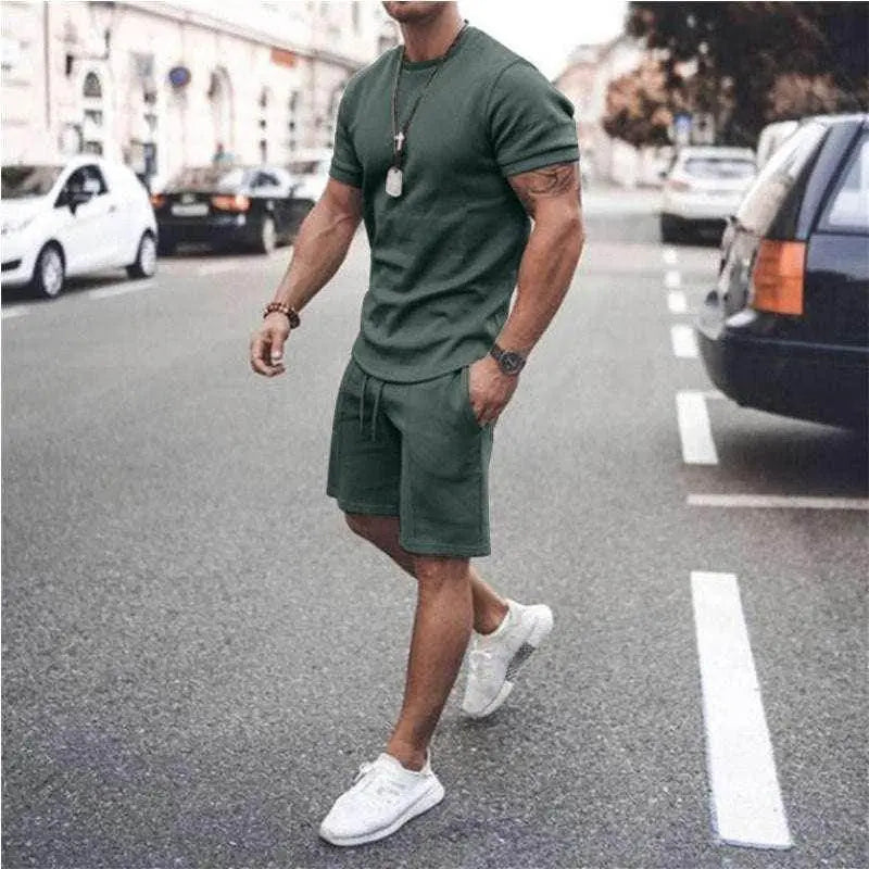 Men's green summer sportswear set with tee and shorts by ZA-Zola, styled on city street.