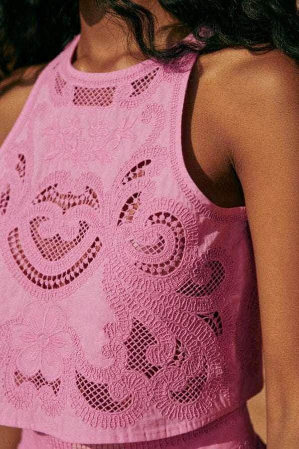 Woman wearing a pink lace sleeveless top, stylish fashion at ZA-Zola United Kingdom