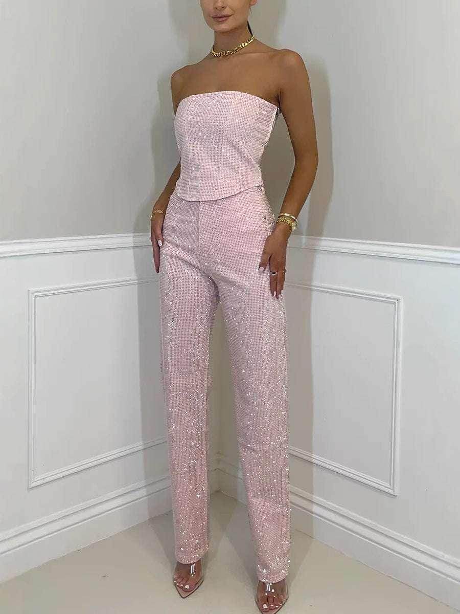 Woman modeling sparkly pink strapless jumpsuit, chic ZA-Zola fashion, white backdrop