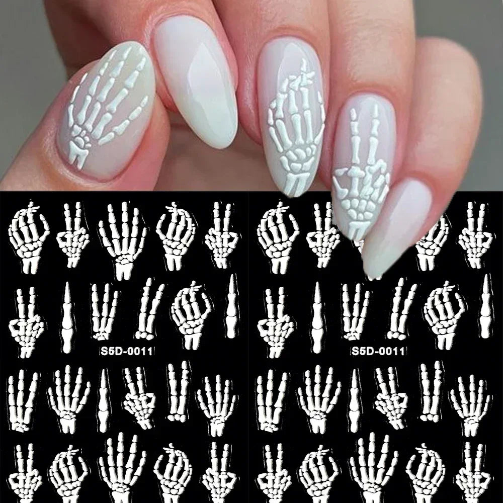 White skeleton hand nail art decals on natural manicured nails, skull hand nail stickers display.
