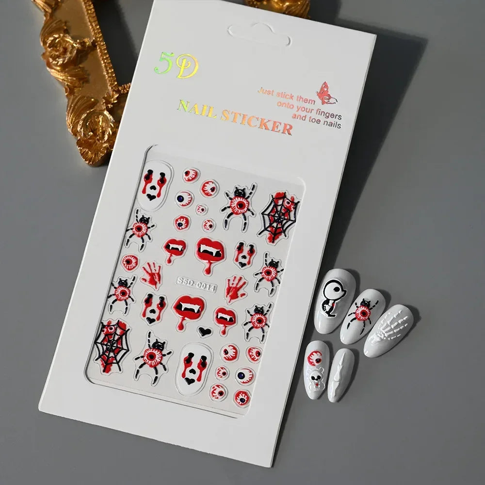 Halloween-themed 5D nail stickers with spooky eyes, vampire mouths, and webs on gray surface