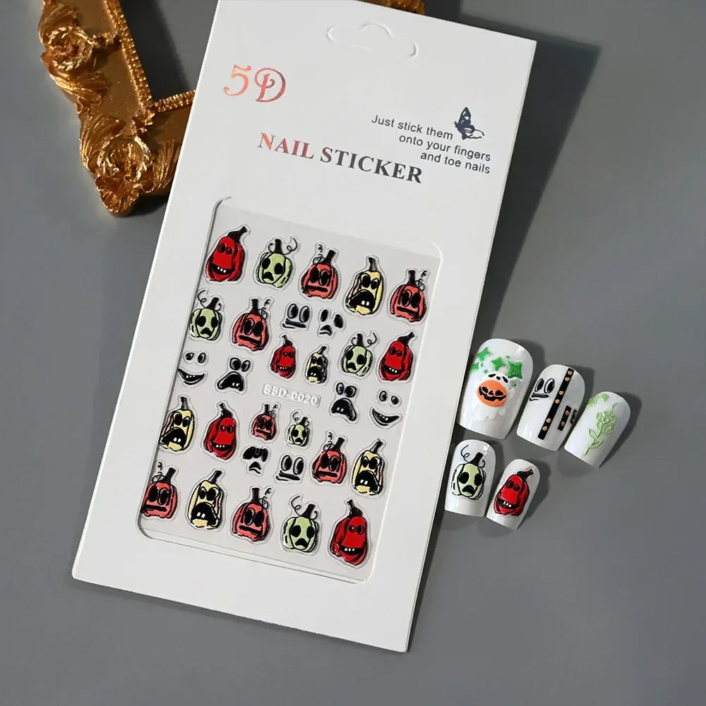 Halloween pumpkin face nail stickers and decorated press-on nails set on gray background