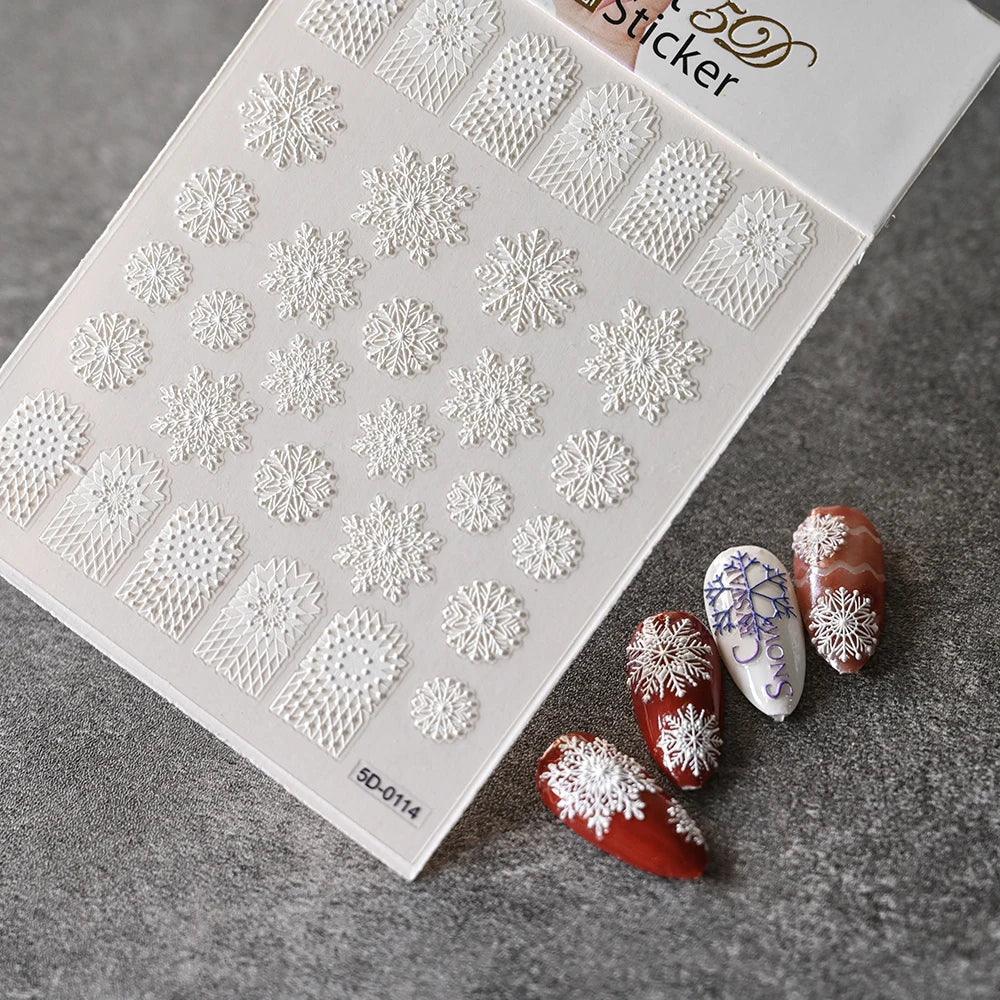 White 3D snowflake nail art stickers with winter designs, shown on red and white nails