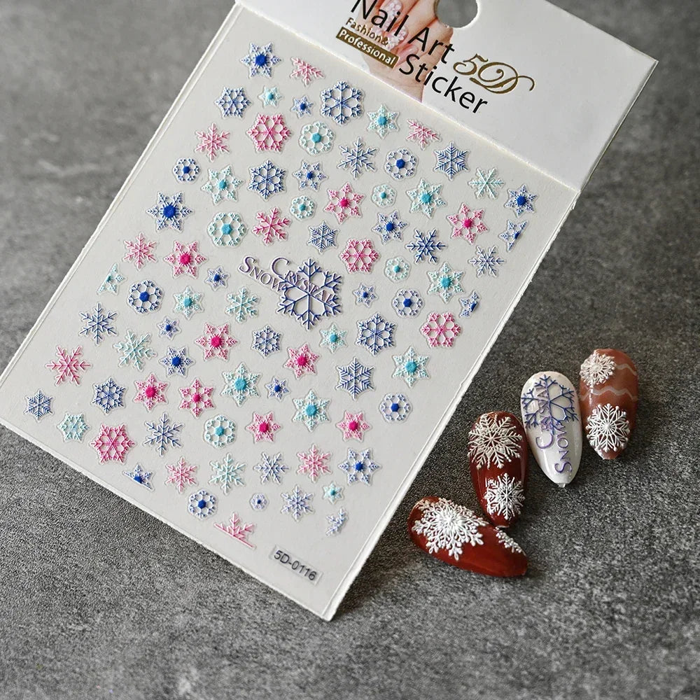 Snowflake nail art stickers in blue, pink, white and sample winter nail designs on display