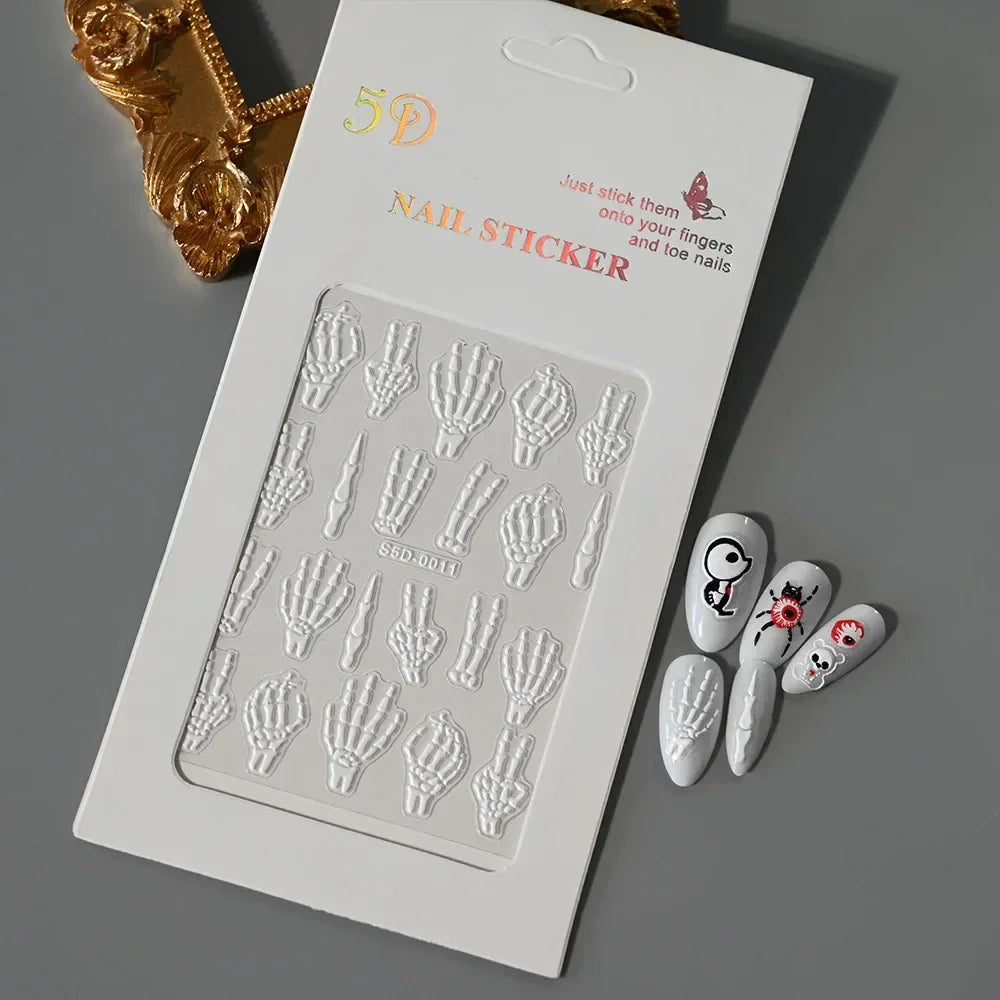 5D skeleton hand nail stickers set with Halloween-themed nail art on a gray background