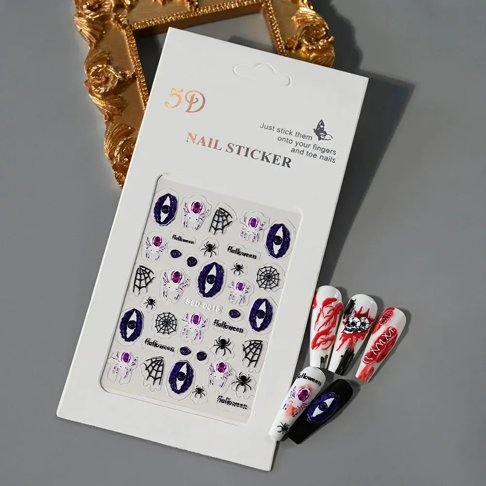 Halloween nail art stickers with spider, web, and eye designs, plus sample decorated nails