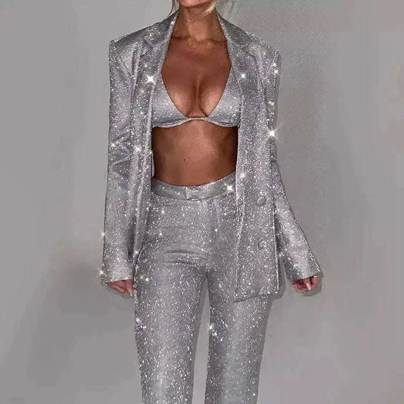 Woman wearing a silver sequin bra, blazer, and trousers party suit set from ZA-Zola