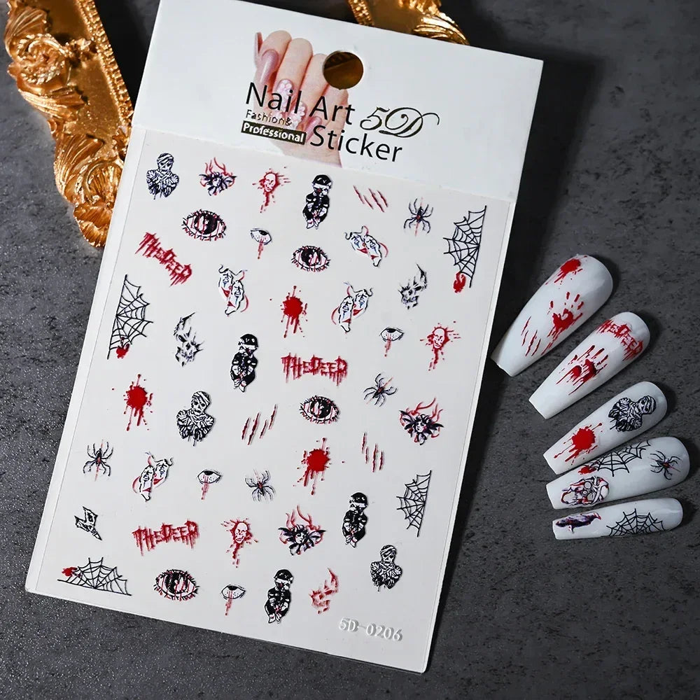 Horror-themed nail art stickers with blood splatters, eyes, spiders, and web designs on display.