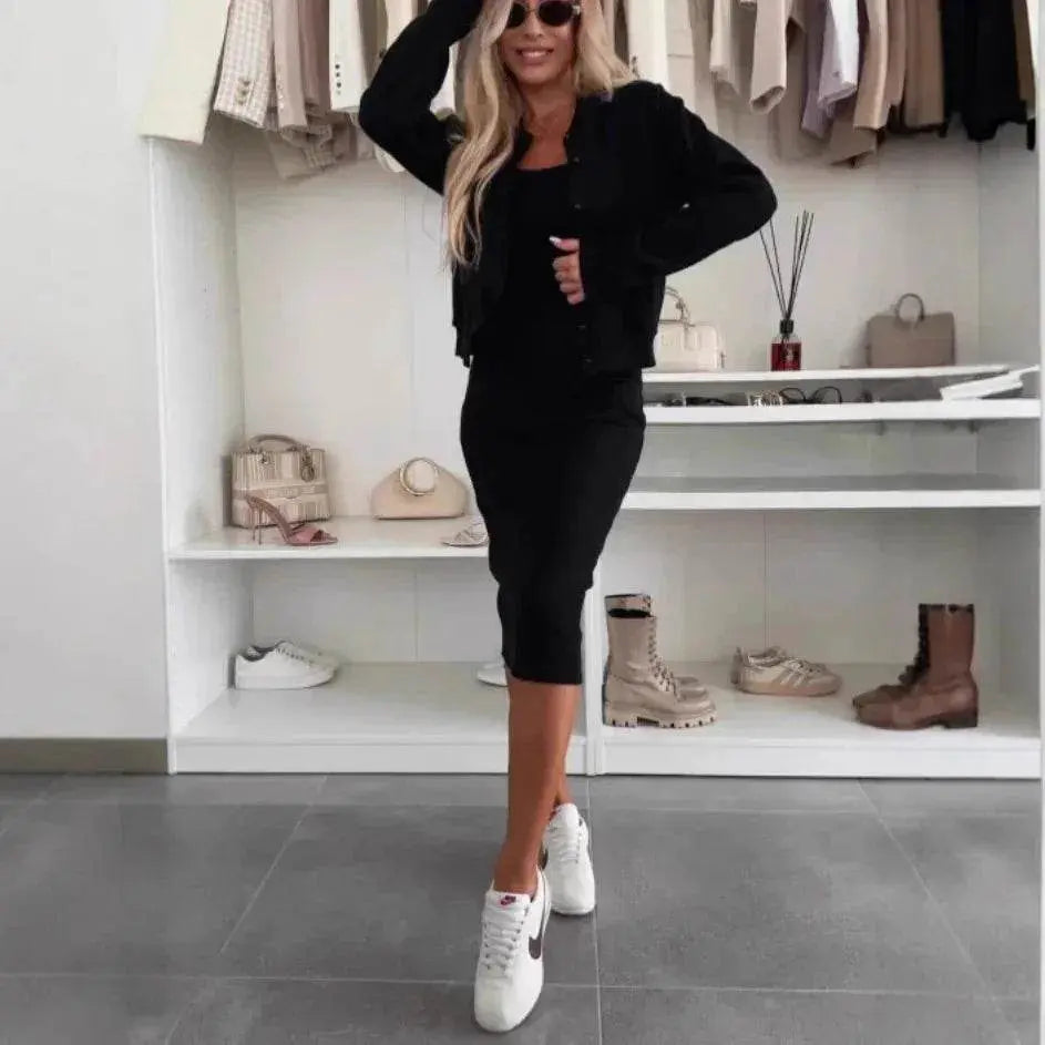 Woman in black cardigan and dress set from ZA-Zola, posing in modern closet with chic accessories