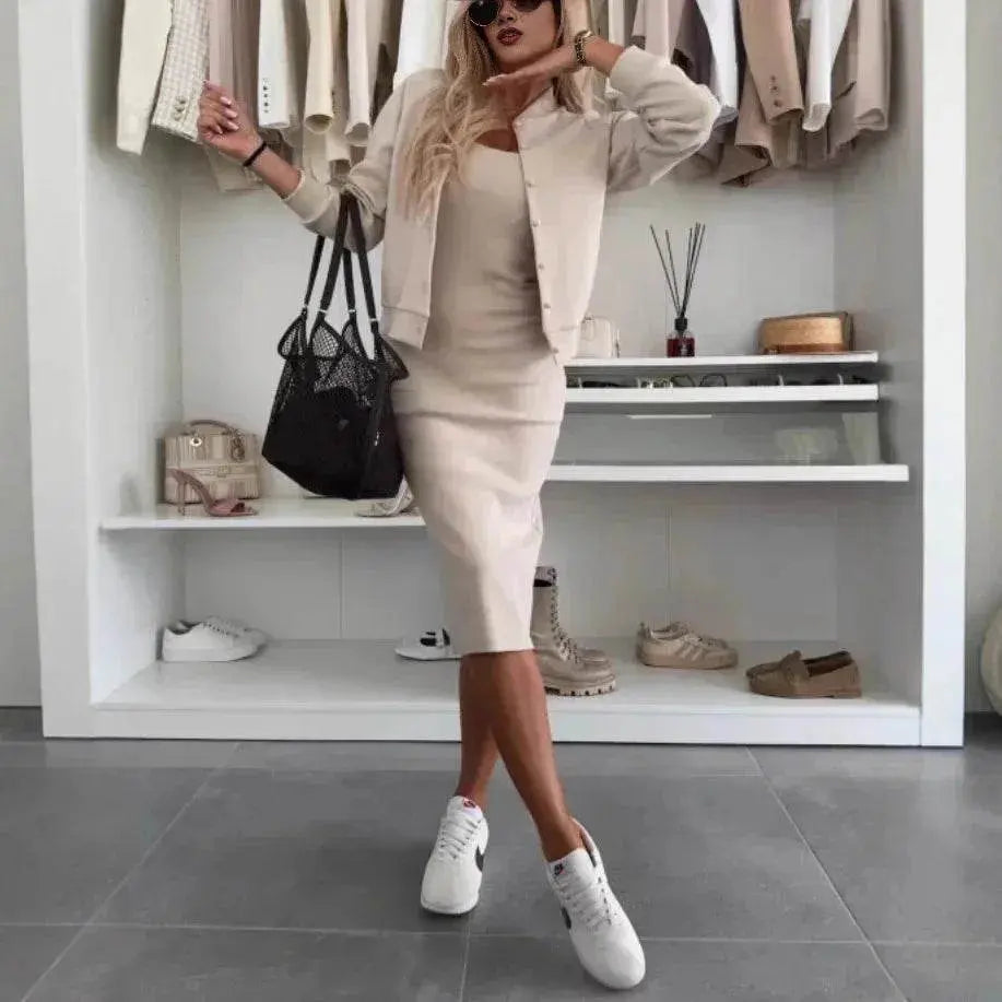 Woman in beige sling dress and cardigan set from ZA-Zola, styled with white sneakers and black tote, standing in a modern closet.