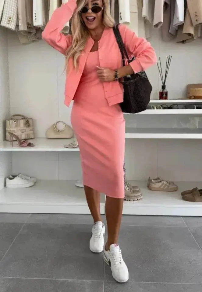Woman wearing a pink two-piece sling dress and cardigan set from ZA-Zola, styled with white sneakers and sunglasses in a modern boutique setting.