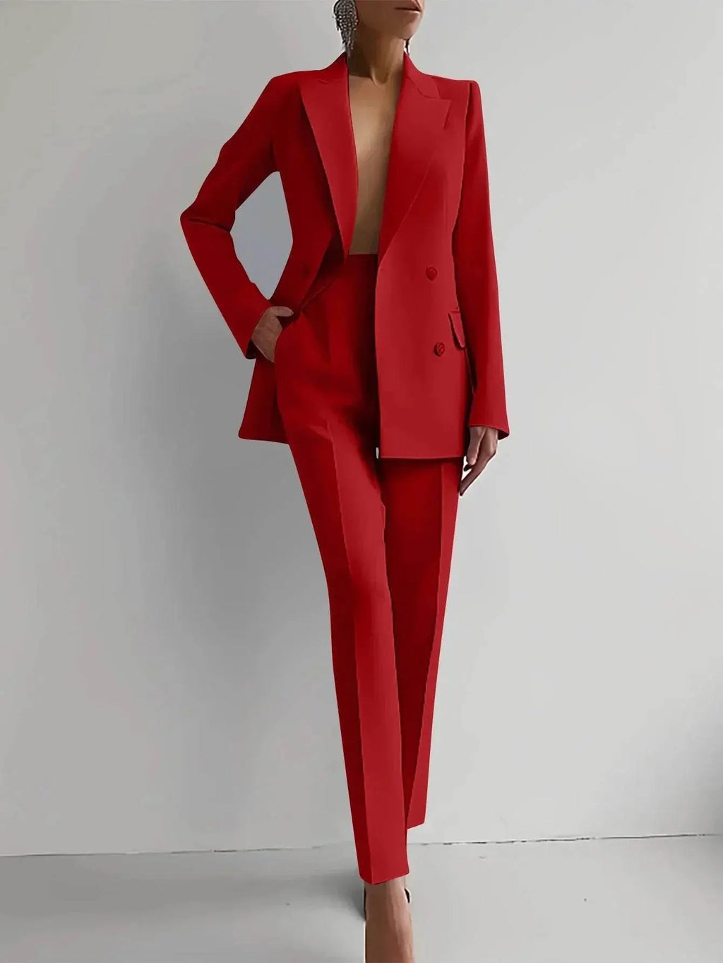 Woman modeling bright red slim-fit blazer and pants suit set from ZA-Zola against plain background