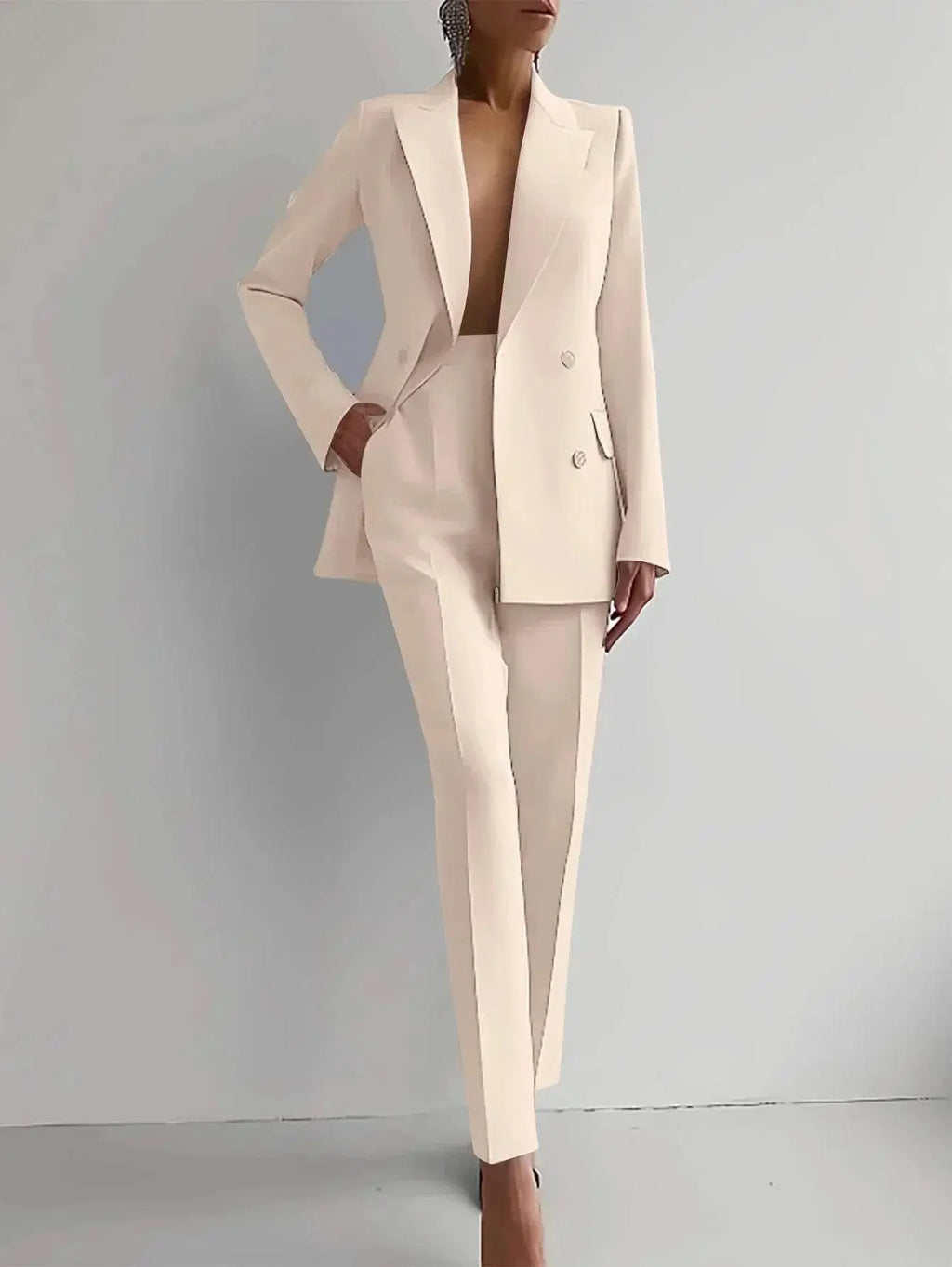 Woman modeling a cream slim-fit blazer and pants set from ZA-Zola against a plain background