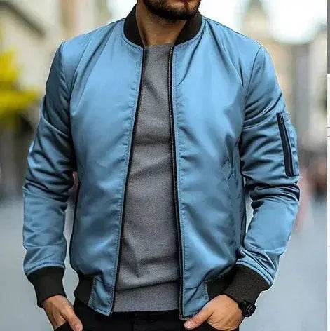 Man wearing light blue slim-fit bomber jacket and grey shirt outdoors, ZA-Zola fashion.