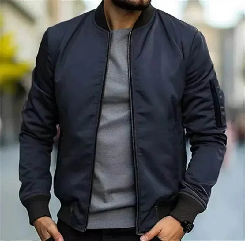 Man wearing a slim-fit navy bomber jacket and grey shirt from ZA-Zola on city street
