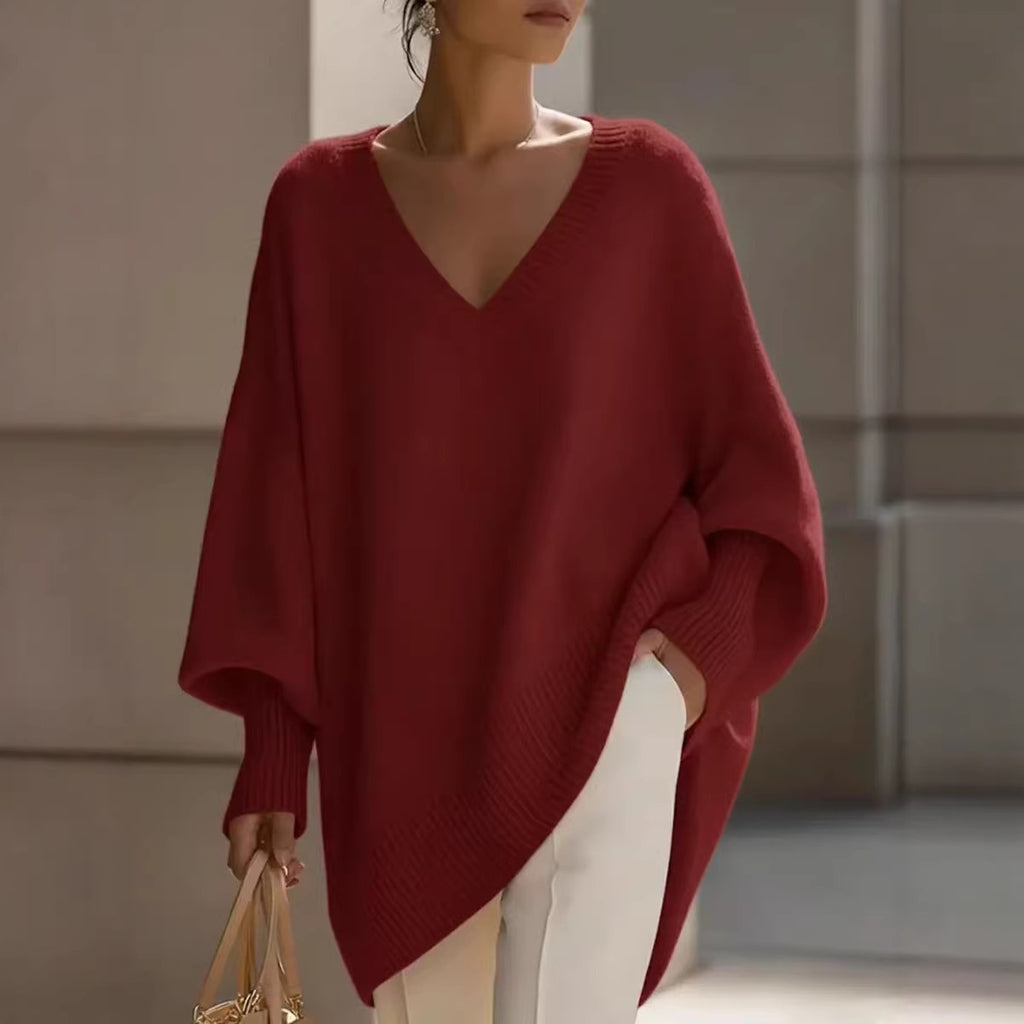 Woman wearing a red sweater and white pants in an indoor setting