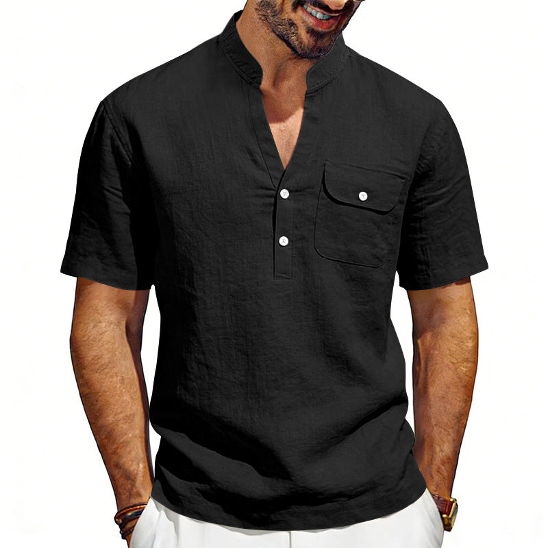 Man wearing a black short-sleeve shirt with button details on a white background