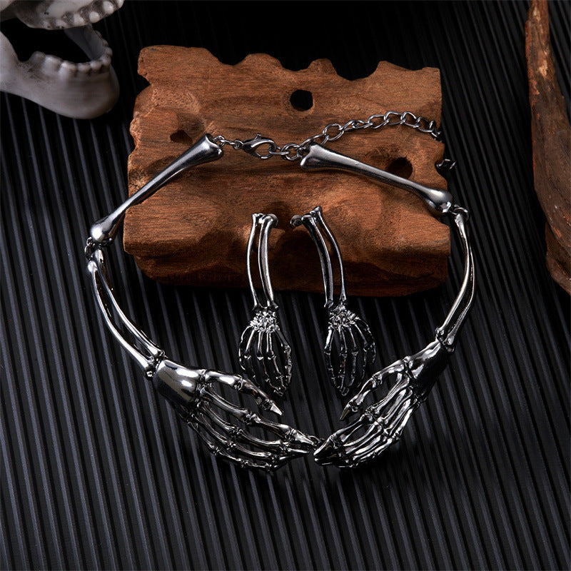 Silver skeleton hand bracelet on a wooden display with a black textured background