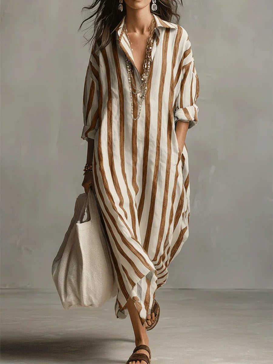 Woman wearing a long, striped dress with a neutral background