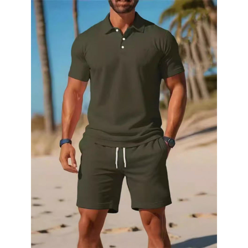 Man wearing a green polo shirt and shorts on a beach with palm trees in the background