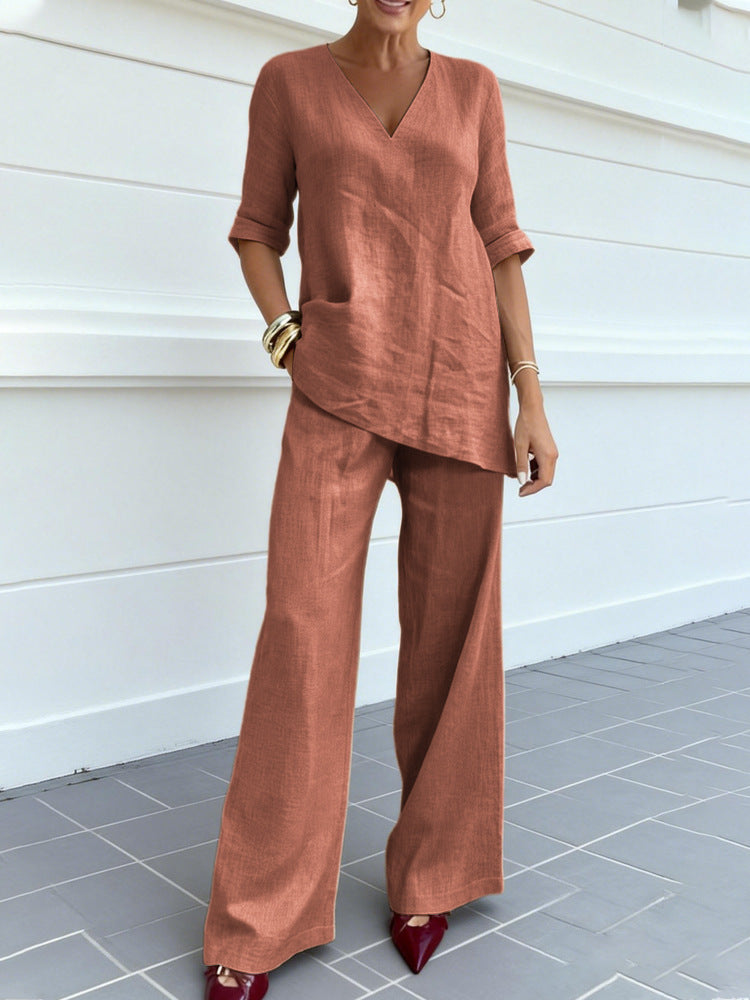 Person wearing a brown outfit standing against a white wall.