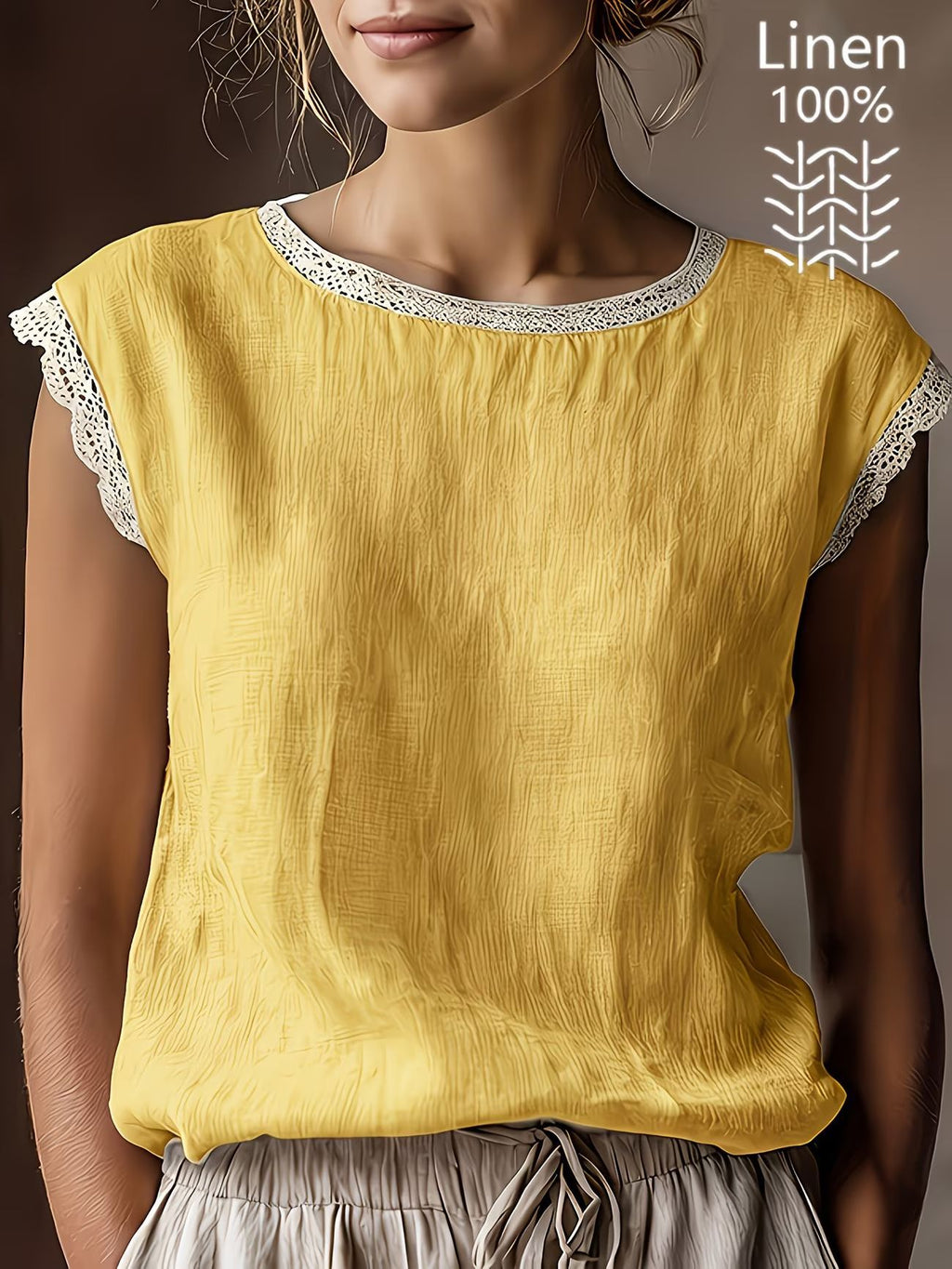 Yellow linen top with lace trim worn by a person, on a dark background