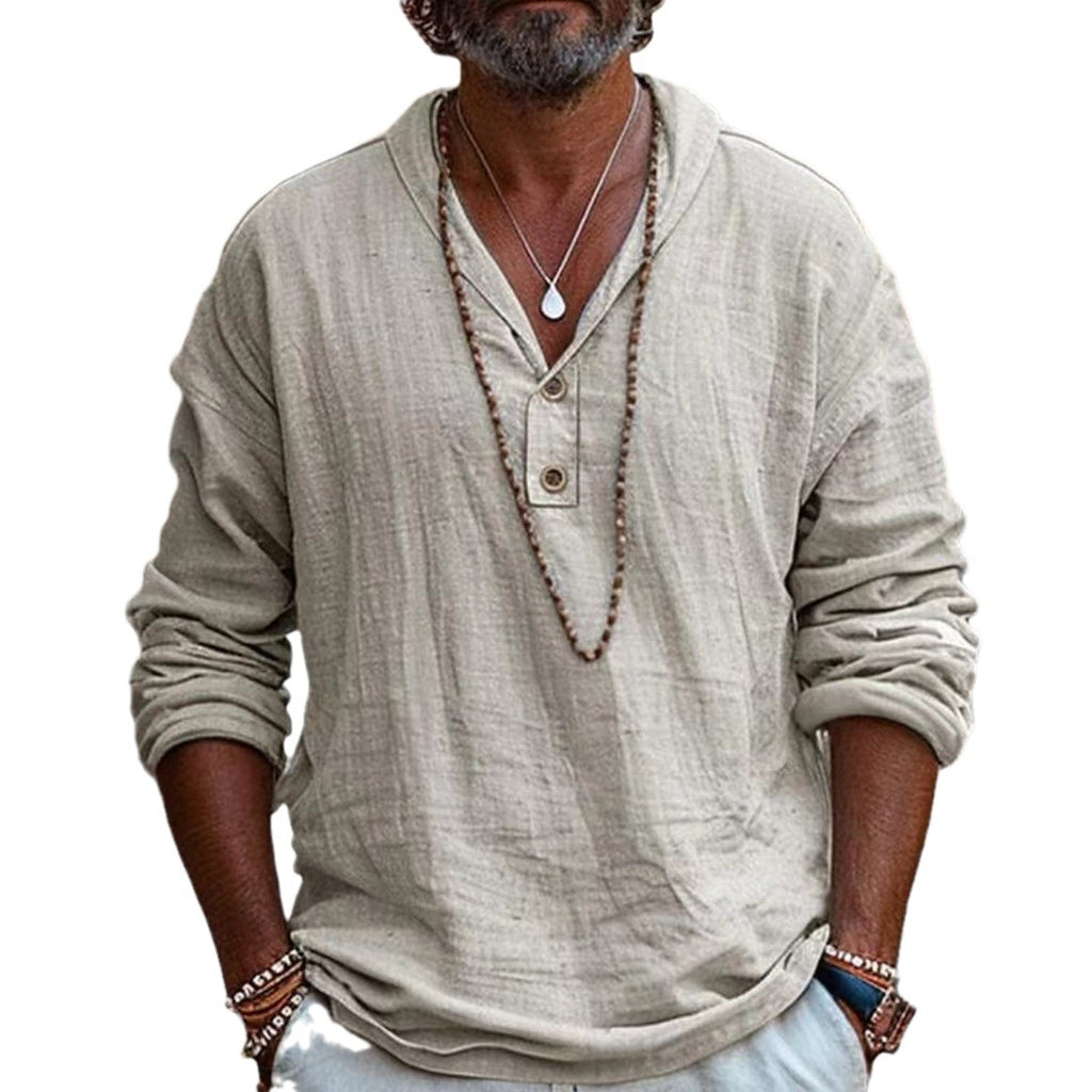 Man wearing a beige long-sleeve shirt with a necklace on a white background