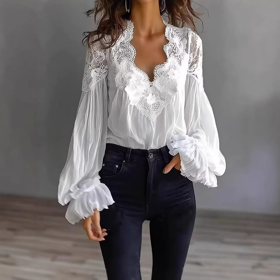 White lace blouse with long sleeves worn by a person against a neutral background
