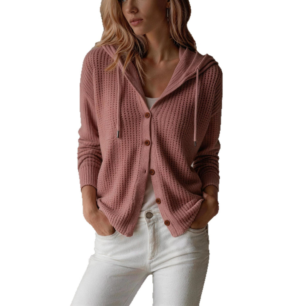 Pink knitted cardigan worn by a person on a white background