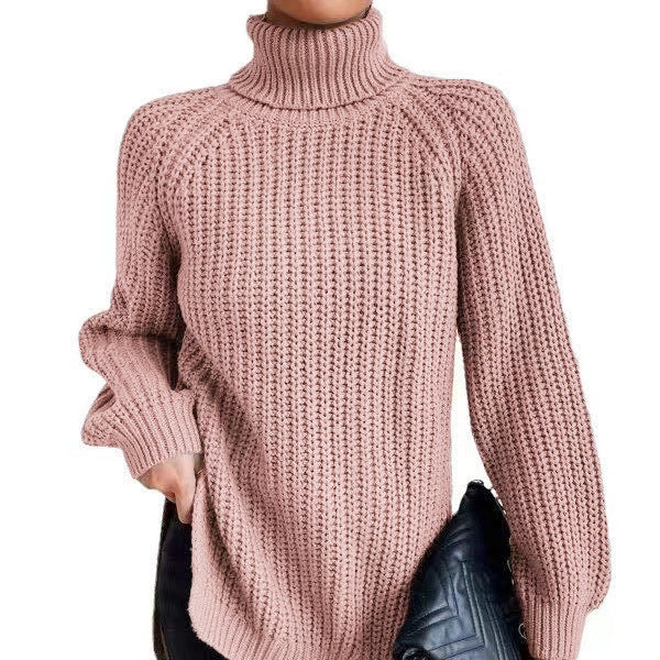 Pink knitted sweater worn by a person on a white background