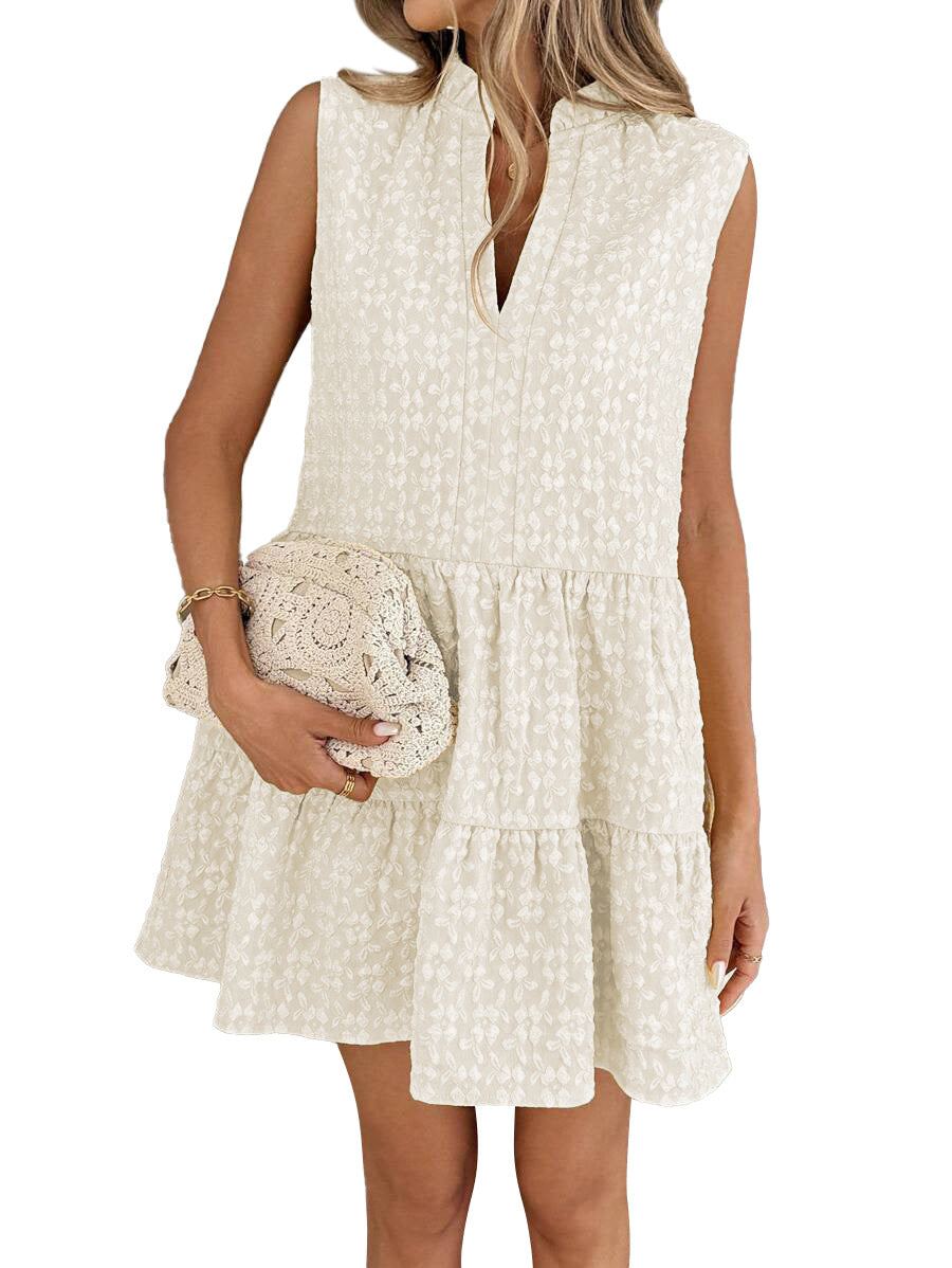 Woman wearing a white sleeveless dress holding a matching clutch against a white background