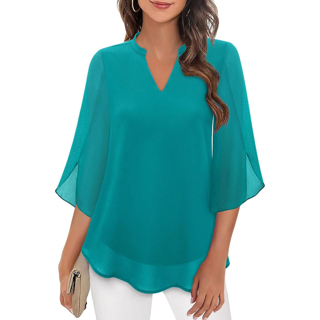 Woman wearing a teal blouse with a plain background