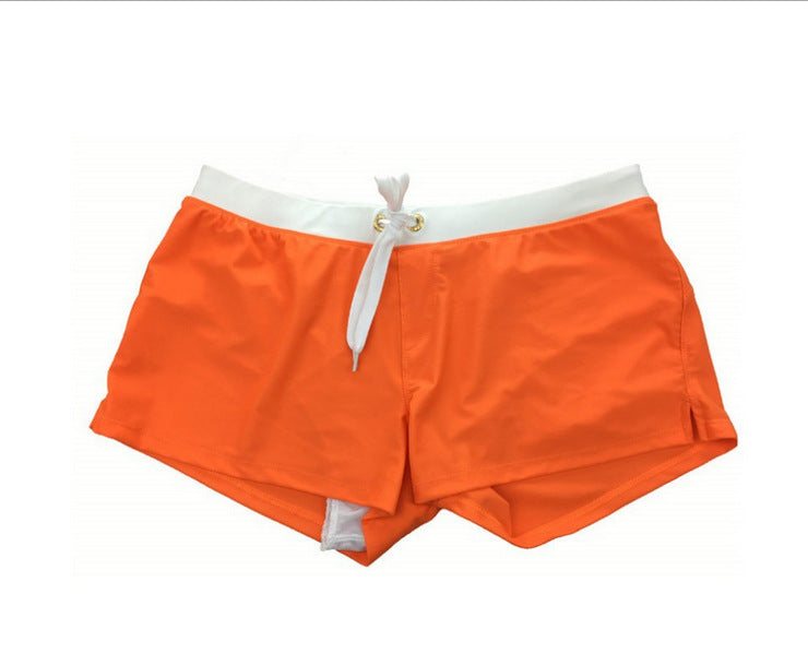 Orange shorts with a white waistband and drawstring on a white background