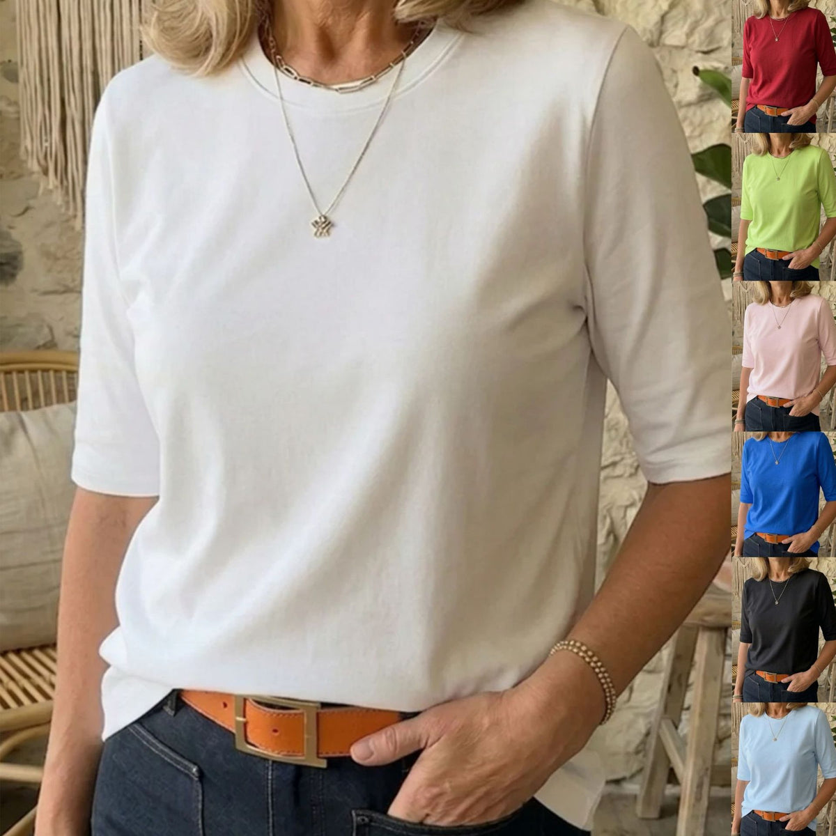 A woman wearing a white short-sleeve crewneck t-shirt, styled with dark blue jeans and an orange-brown belt. The image features a vertical strip of smaller color options on the right side showing the t-shirt in red, green, pink, blue, black, and light blue.